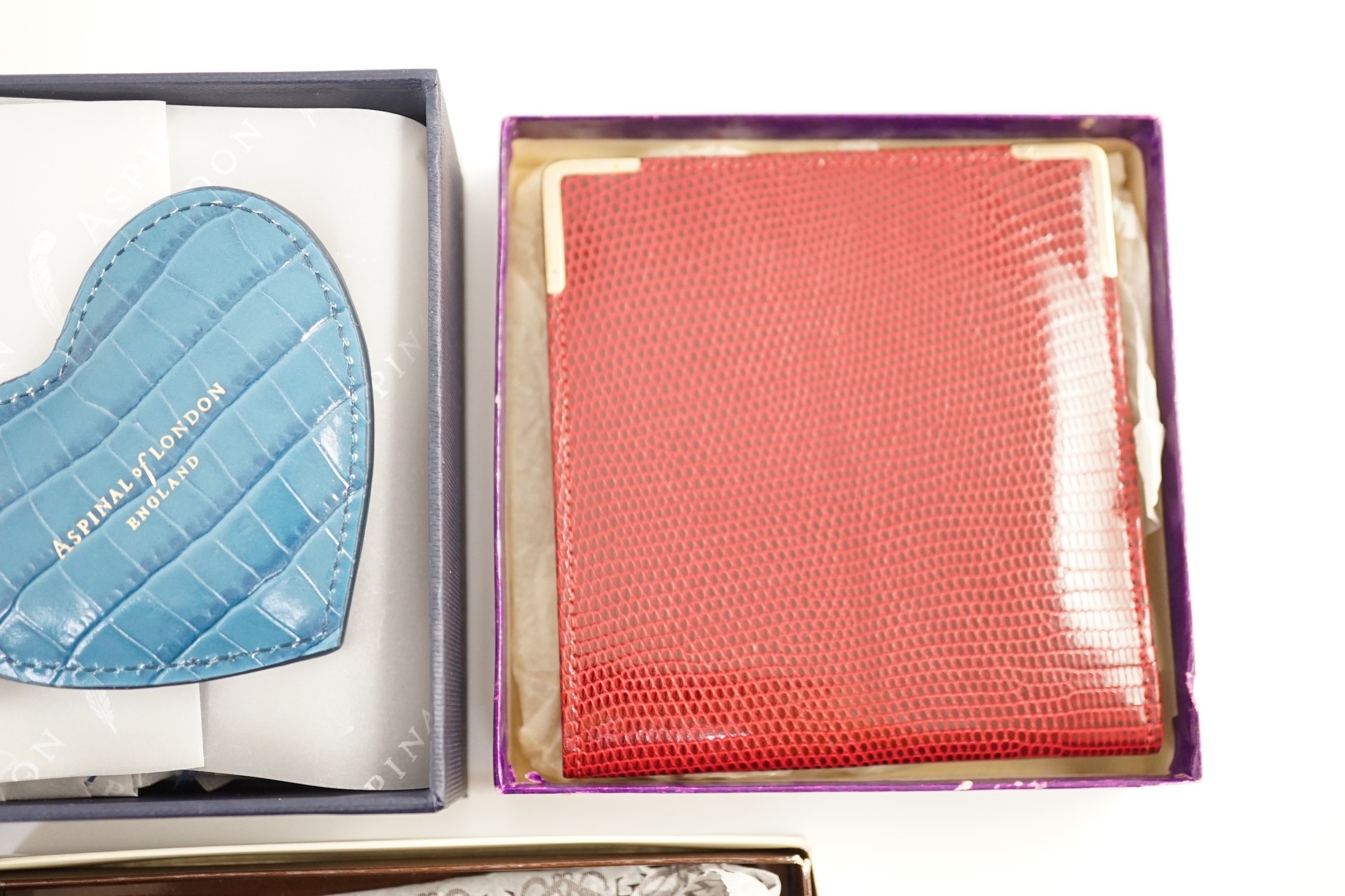 A set of two Asprey leather address books (initialled), an Asprey snakeskin wallet, a Loewe brown leather wallet and an Aspinal heart key fob
